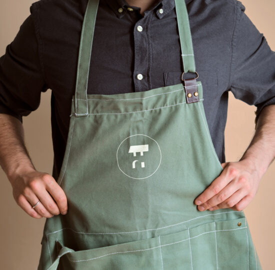 The Froidmont farm logo on a Froidmont worker's apron